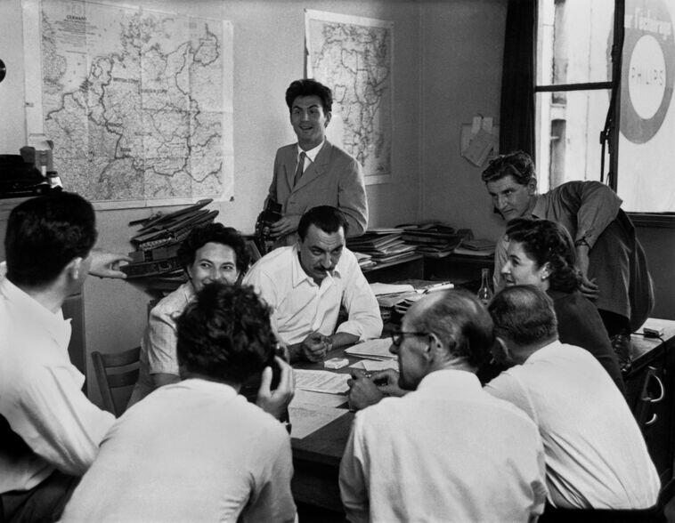 FRANCE. Paris. 1950. A Magnum Photos meeting.From left to right: Robert Capa, Maria Eisner, Alberto Mondadori (Epoca), Ernst Haas (standing), George Rodger, Joan Bush, David Seymour, Leonard Spooner (Illustrated), Werner Bischof.